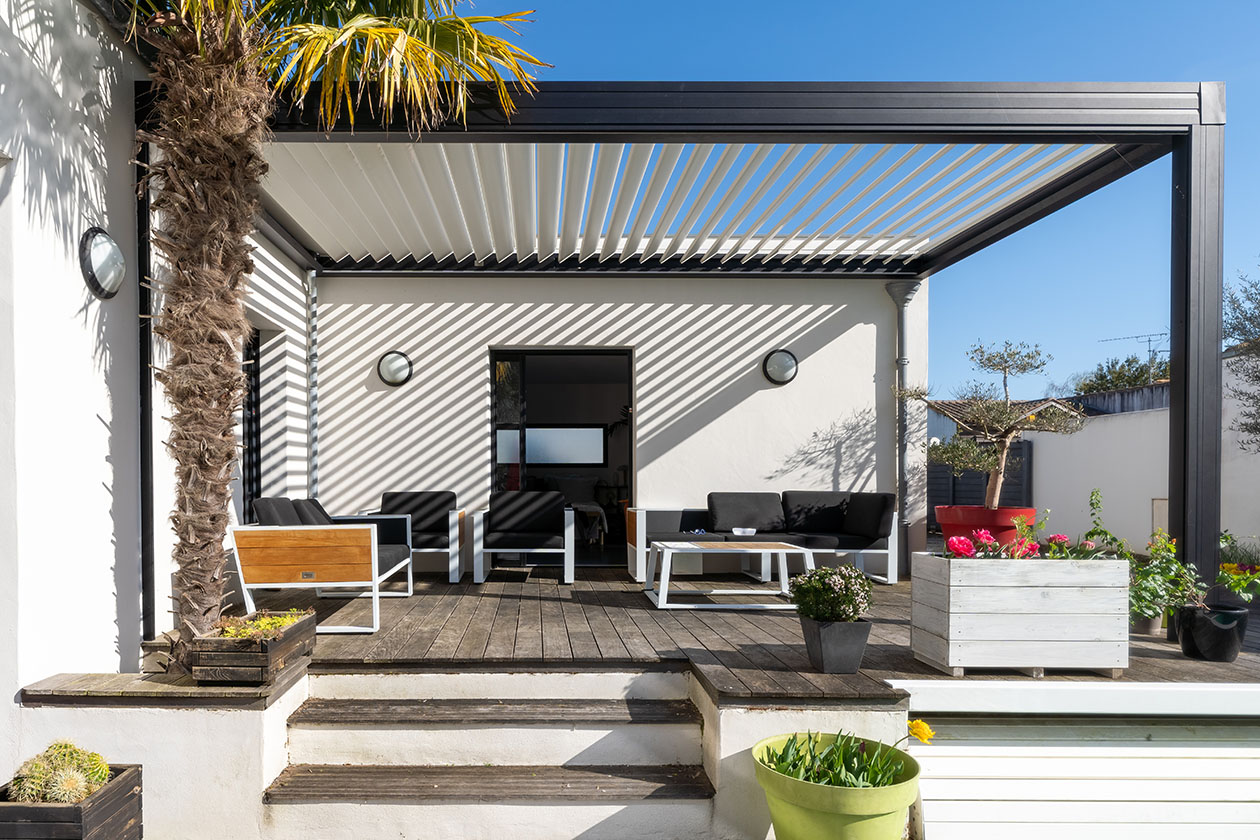 Pergola with aluminum retractable roof covering out door lounge area