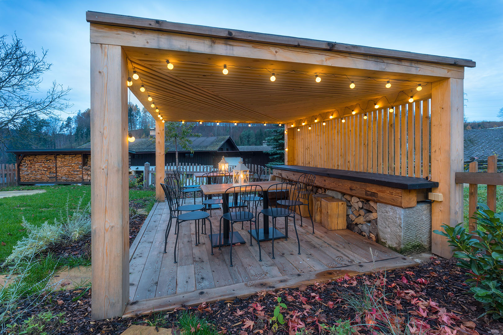 Pergola sheltering outside dining area in garden
