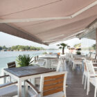 Riverside terrace cafe with retractable awning roof